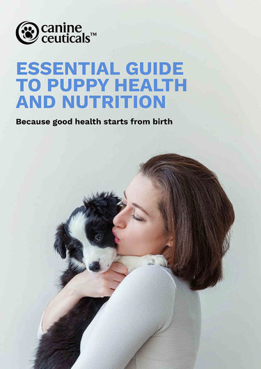 Woman holding a puppy with CanineCeuticals guide to puppy health and nutrition on a light background